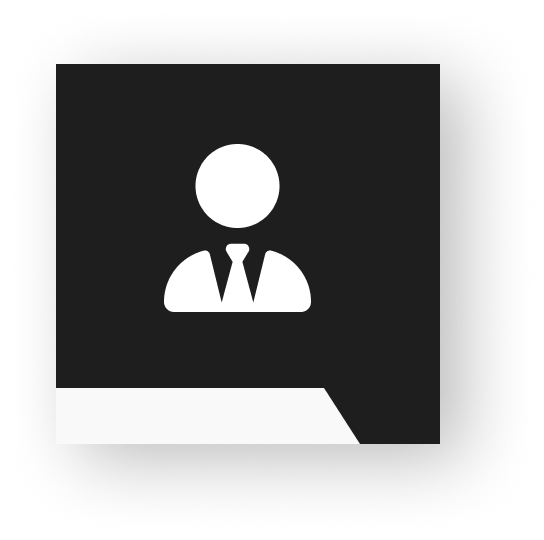 A simple icon of a real estate expert in a suit and tie behind a desk on a black background.